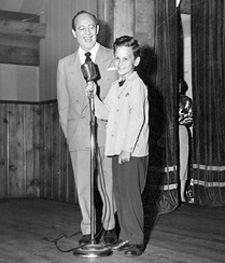 Young Bill on stage with his dad Ned and mom Sandy in wings